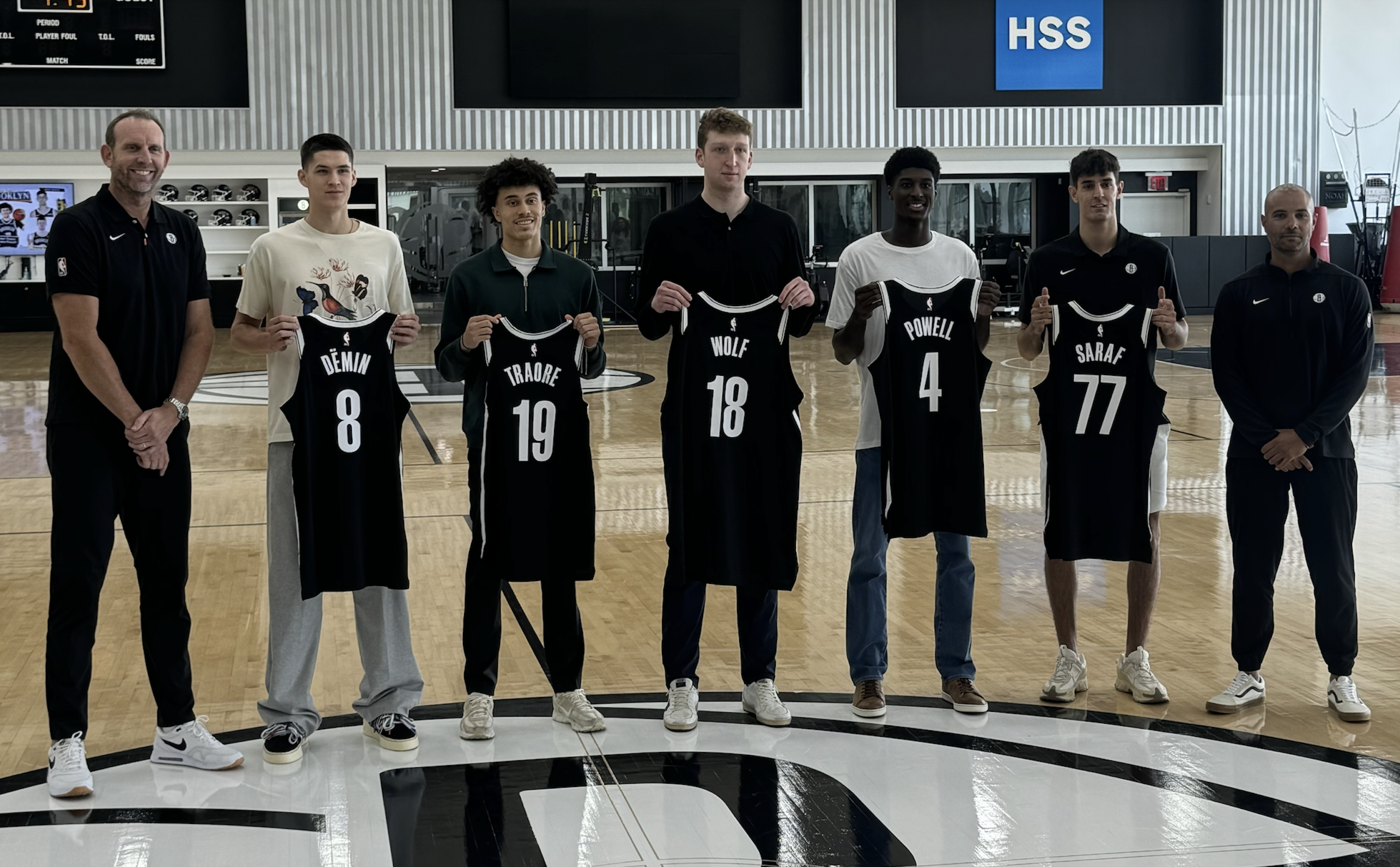 Brooklyn Nets General Manager Sean Marks (left) and head coach Jordi Fernandez (right) pose with the team's rookie class at HSS Training Center.